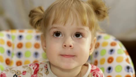 Beautiful-two-years-old-girl.-Cute-blonde-child.-Brown-eyes.-Close-up