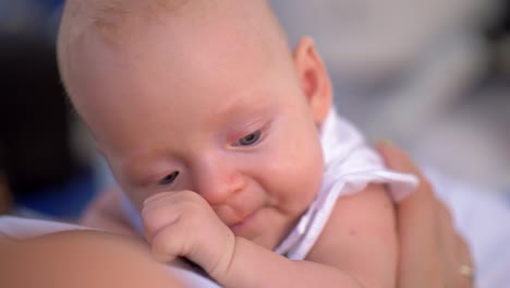 Three-months-baby-girl-in-mothers-hands