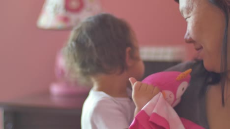 A-toddler-has-her-mother-give-her-stuffed-animal-a-kiss