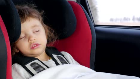 baby,-child-sleeping-in-the-car-seat-while-driving