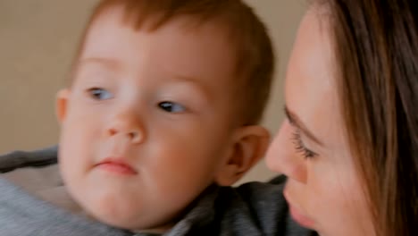 Happy-young-mother-and-her-baby-son-playing-togerher