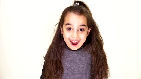 Little-cute-caucasian-girl,-smiling,-showing-an-emotion-of-surprise,-wide-open-mouth,-portrait-white-background-50-fps