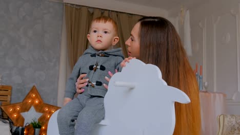 Niño-jugando-con-caballo-de-madera-mecedora