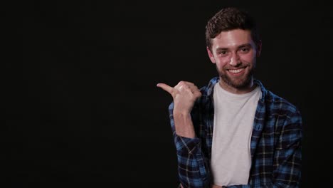 A-Young-Man-Mimicing-Against-a-Black-Background