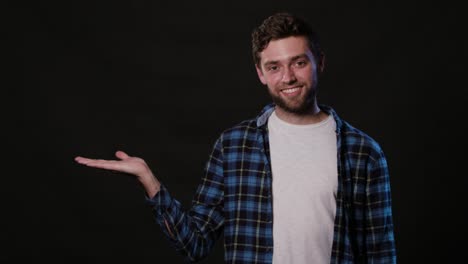 A-Young-Man-Mimicing-Against-a-Black-Background