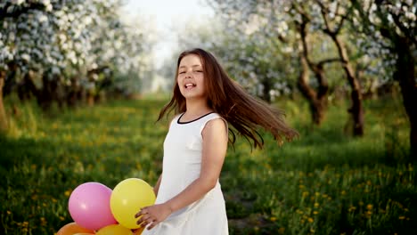 Young-girl-in-a-blooming-apple-orchard