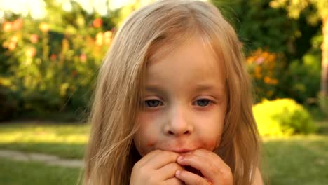 Little-girl-enjoys-eating-tomato-with-pleasure