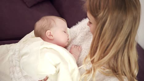 Adorable-baby-sleeping-on-mother-hands.-Toddler-sleep-in-mother-embrace