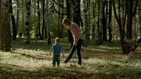 Mother-with-son-walking-outdoor-in-autumn