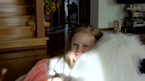 Adorable-little-girl-sit-on-big-soft-toy-and-smiling