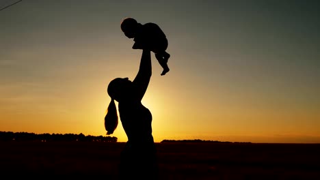 Silhouette-of-mother-with-child-at-sunset