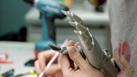 Close-up-of-artificial-hand-limb-is-being-painted