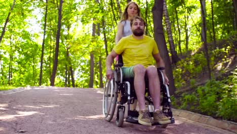 Young-disable-man-on-a-walk-in-the-park-with-his-wife