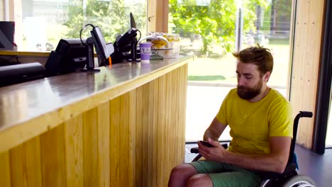 Young-disable-man-in-wheelchair-in-the-cafe