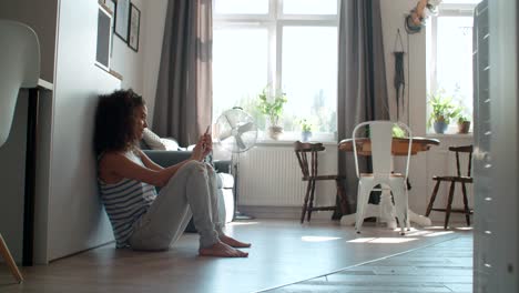 Young-woman-typing-on-mobile-phone-at-home.