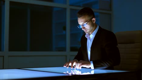 The-businessman-working-with-a-sensor-display-on-the-hologram-background