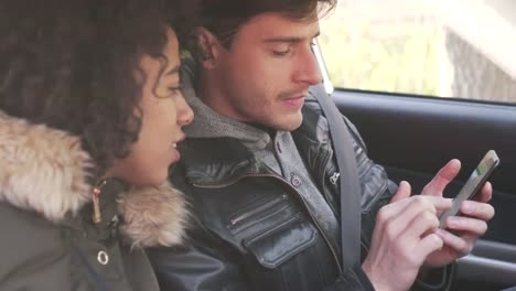 Couple-using-navigation-on-mobile-phone-in-car