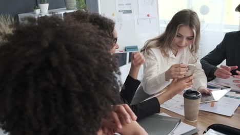 Business-people-enjoying-media-content-on-mobile-phone