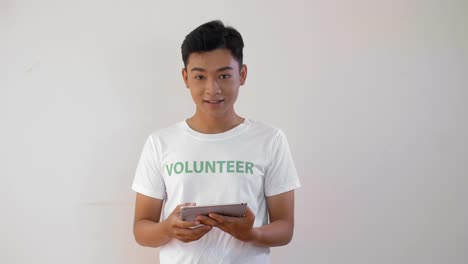 Male-Asian-Volunteer-with-Tablet