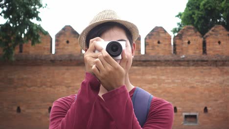 Young-traveler-take-a-photo-with-digital-camera.