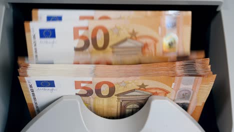 Money-counting-machine-with-euros-in-it