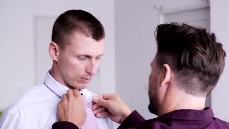 Gay-man-help-his-partner-putting-on-tie-for-job-interview.-Tidy-up-necktie.