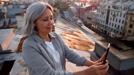 Grey-haired-Female-Tourist-on-Roof