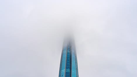 The-Spire-of-Skyscraper-in-Low-Clouds.