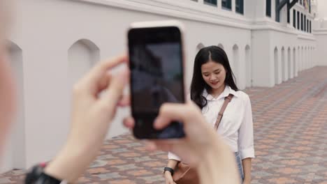 Asian-lesbian-couple-using-smartphones-taking-a-photo.-Beautiful-Asian-women-traveling-with-a-friend's-vacation-time.-LGBT-concept.