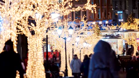 New-Year's-city-with-luminous-houses-and-trees-with-cheerful-walking-passers-by