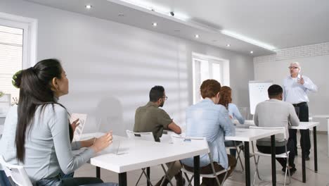 Senior-Teacher-Giving-Lecture-to-Students-in-Futuristic-College-Classroom