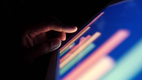 Closeup-of-man-hand-analyzing-bar-chart-on-digital-tablet