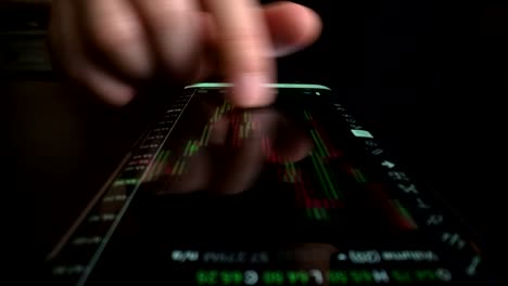 Businessman-reading-stock-market-chart-on-mobile-phone,-trading-online.