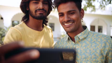 Indian-friends-outdoor-in-nature-park-using-smart-phone-mobile