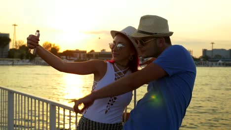 Couple-taking-selfie-at-sunset-on-a-pontoon