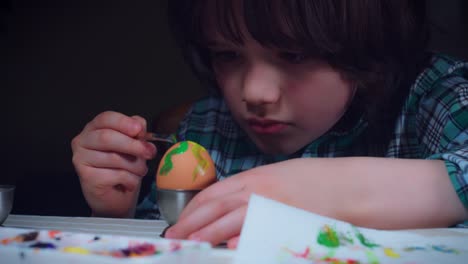 4K-Home-Shot-Of-Child-Painting-Easter-Eggs