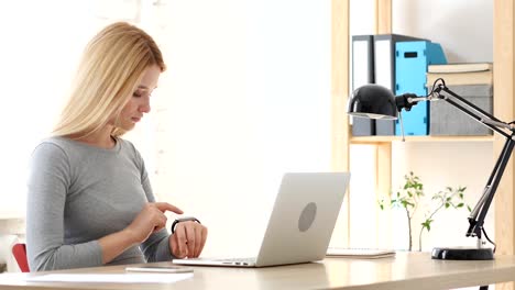 Young-Woman-Using-Smartwatch