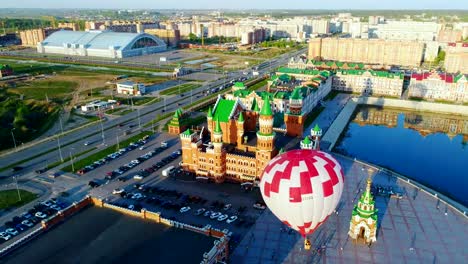 Balloon-is-rising-at-city-square.-Video,-flight-above-Yoshkar-Ola,-Russia