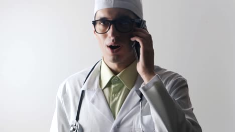 The-doctor-speaks-on-a-mobile-phone.-A-medical-worker-makes-a-phone-consultation.