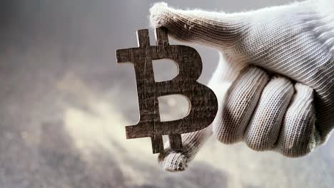 hand-holds-the-symbol-of-bitcoin