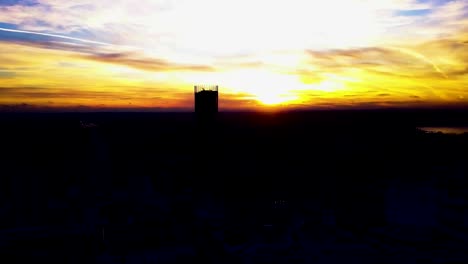 Aerial-view-on-beautiful-colorful-dramatic-sunset-sky-over-silhouette-of-the-city.-Clip.-City-silhouettes-at-sunset-with-skyscrapers-background.-Sunset-in-town-with-business-centres-background