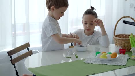 Happy-easter!-Two-boys-having-fun-paint-and-decorate-eggs-for-holiday