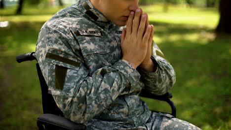 Paralyzed-american-soldier-praying-in-wheel-chair,-asking-for-help,-problem