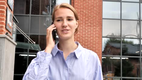 Walking-Woman-Discussing-on-Phone-Call