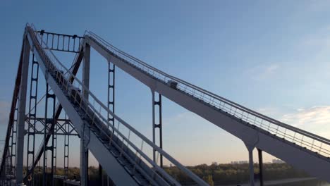 Aerial-shooting-pedestrian-bridge-of-Kiev-on-sunrise.-Summer-morning-in-Kiev-Dniepeer-river.-Ukraine.-European-city