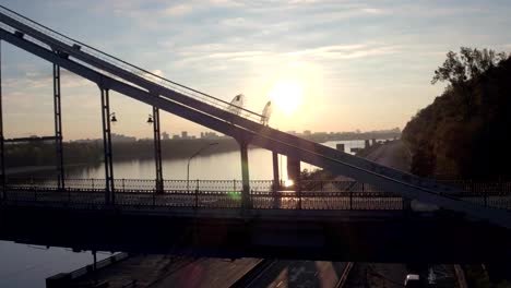 Aerial-shooting-pedestrian-bridge-of-Kiev-on-sunrise.-Summer-morning-in-Kiev-Dniepeer-river.-Ukraine.-European-city