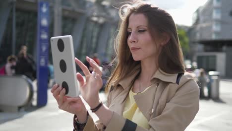 Young-attractive-Caucasian-woman-using-tablet-computer-at-train-station