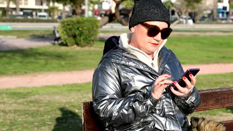 Woman-using-smartphone-at-the-outdoor