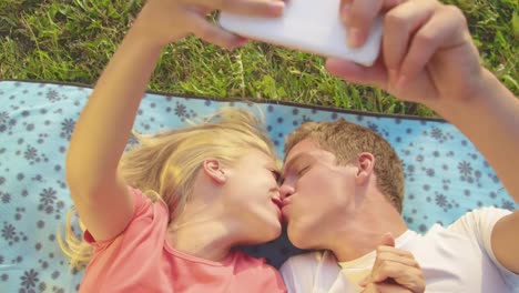 CLOSE-UP:-Adorable-newlyweds-kiss-as-they-lie-on-the-blanket-and-take-selfies.