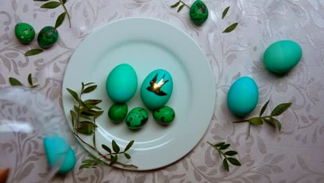 Hand-removes-dome-from-a-plate-with-green-eggs